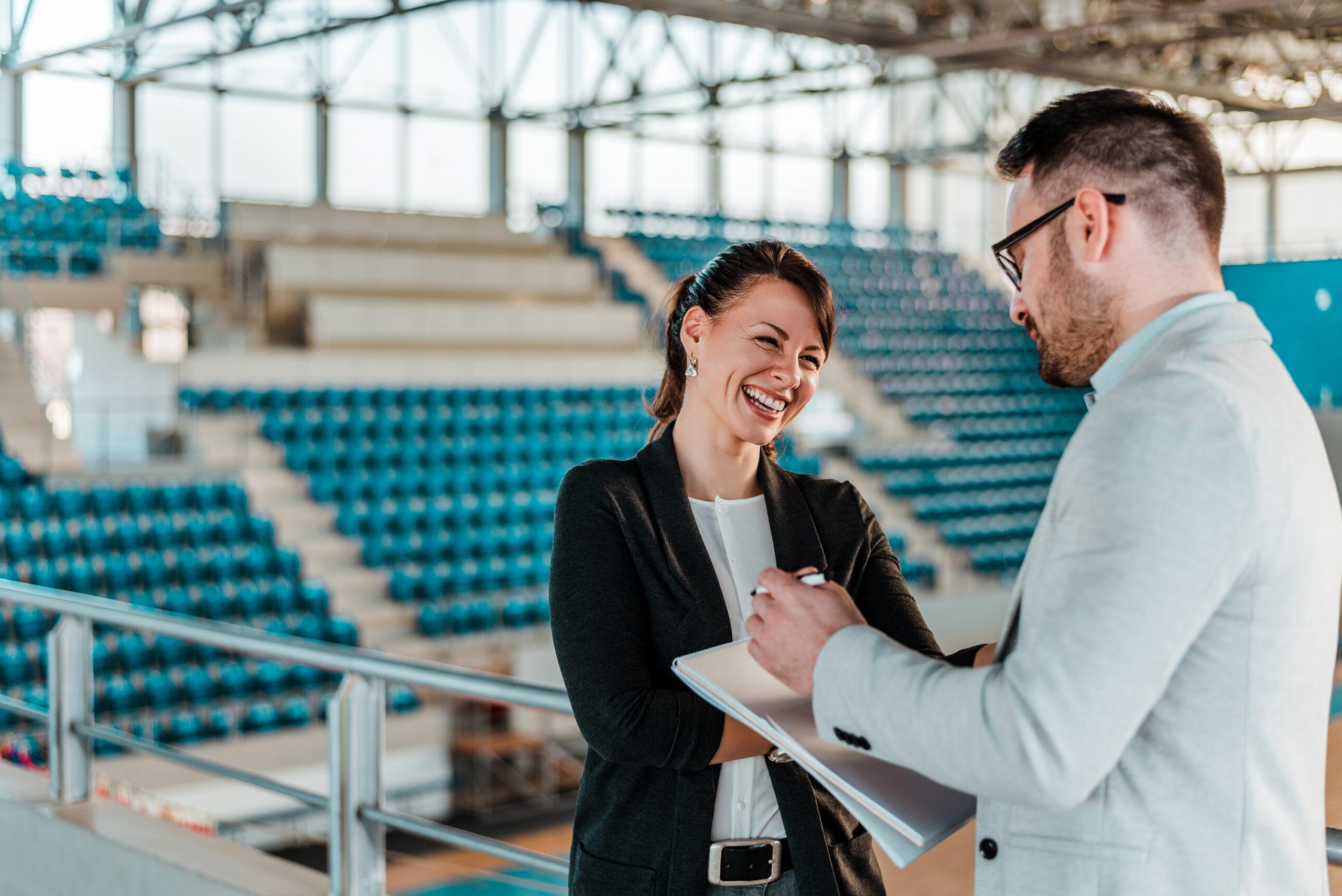 Sport managers conversing in athletics arena